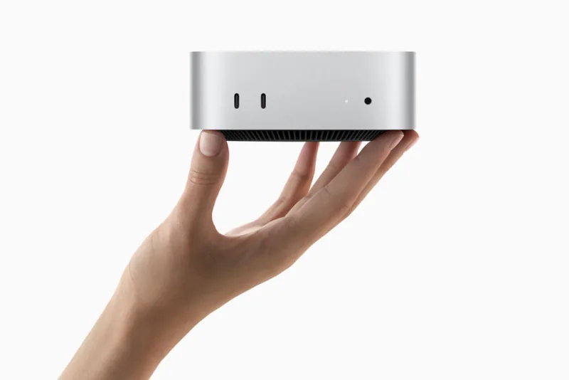 Compact silver Mac mini held in one hand